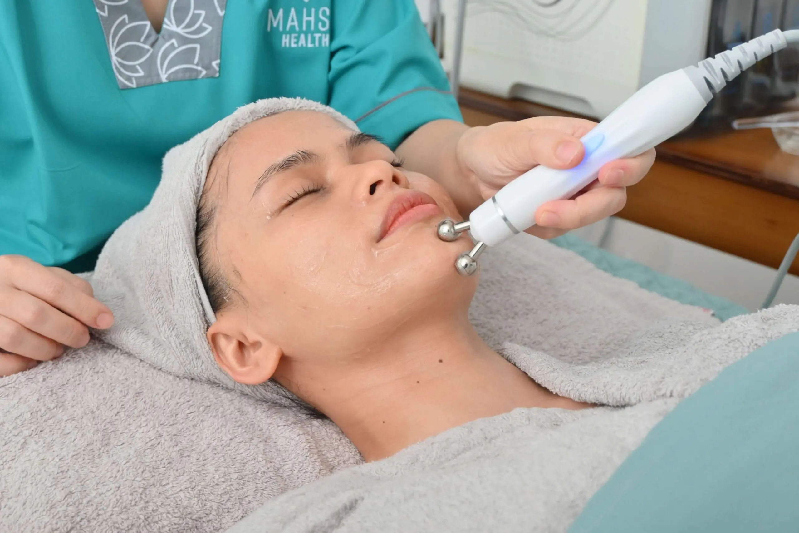 Advanced facial treatment using microcurrent technology at MAHSA Health Nexus for skin rejuvenation and radiance.