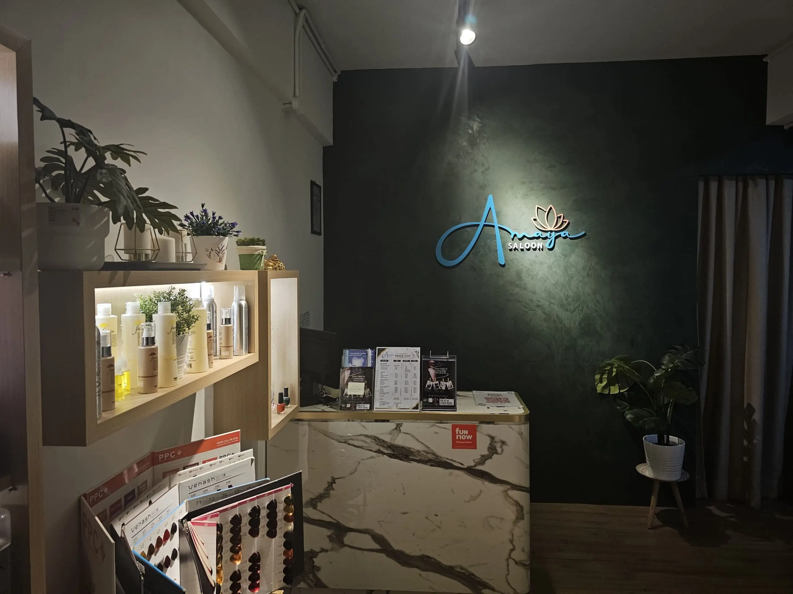 Reception area of Amaya Hair Salon featuring modern decor and professional haircare products at MAHSA Health Nexus.