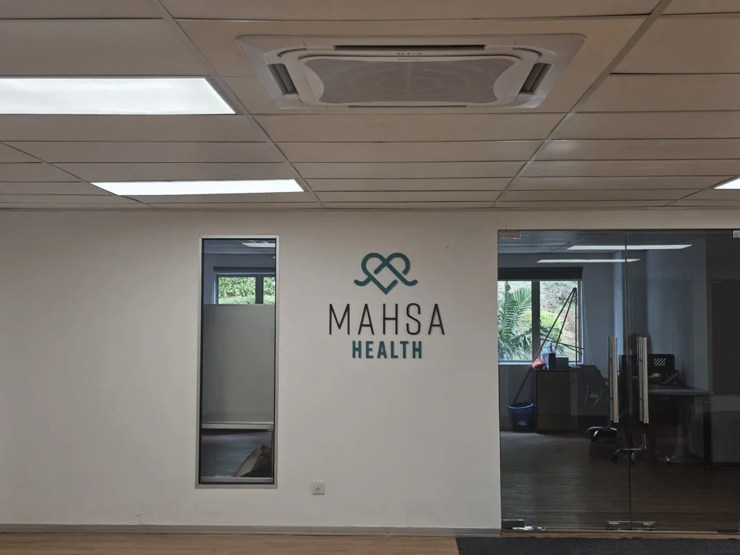 Entrance to the MAHSA Health office featuring a sleek, modern design at MAHSA Health Nexus.